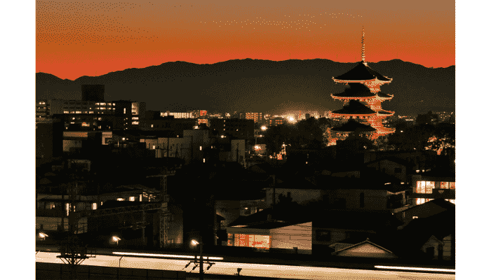 Toji Temple five-story pagoda illuminated at sunset in Kyoto.