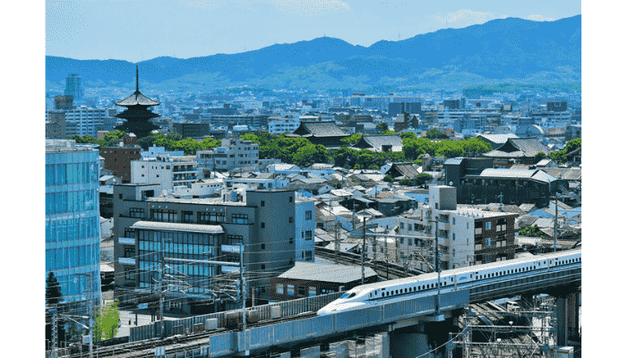 Toji Temple with Shinkansen passing in Kyoto at dusk.